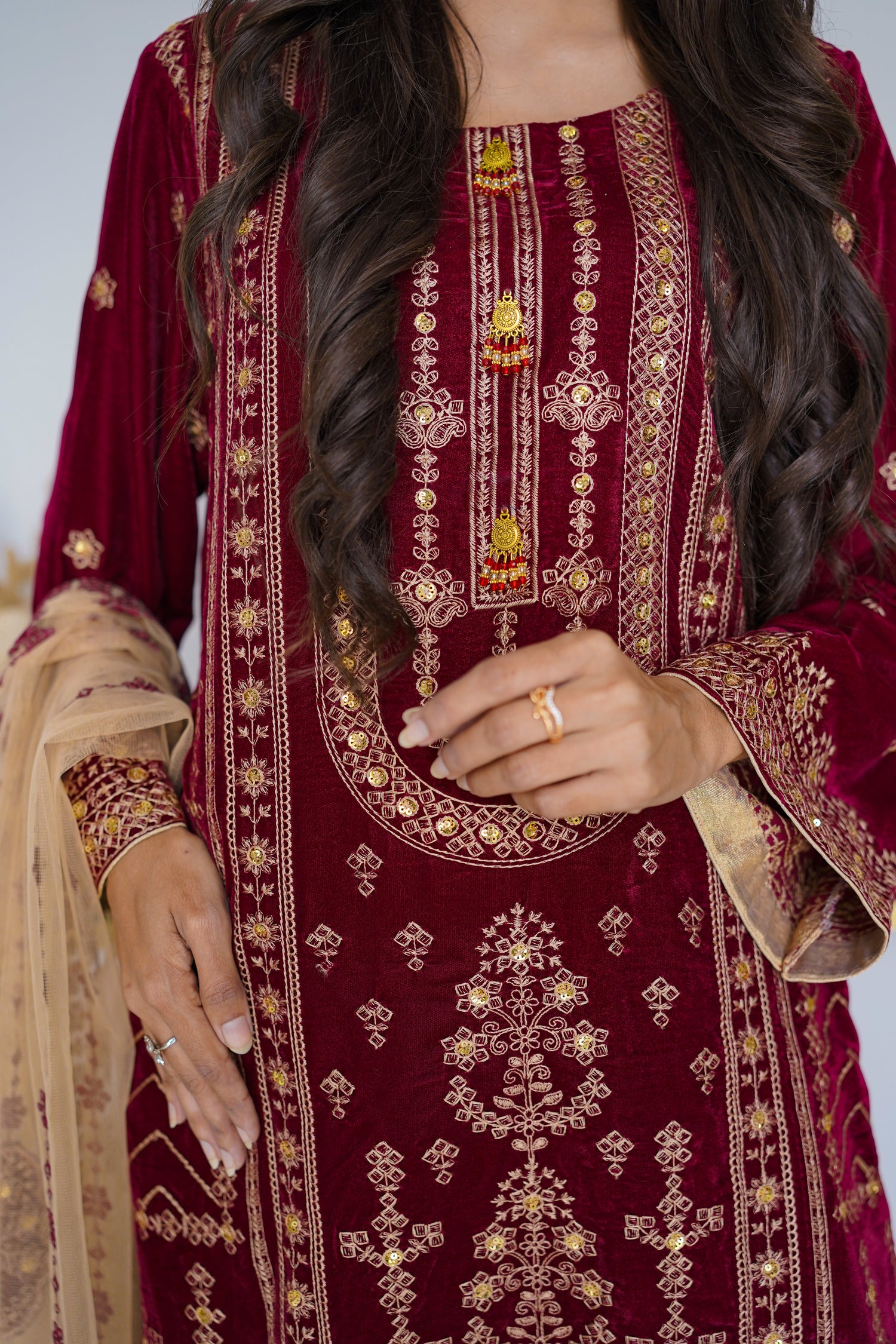 Maroon embroidered traditional outfit with gold details